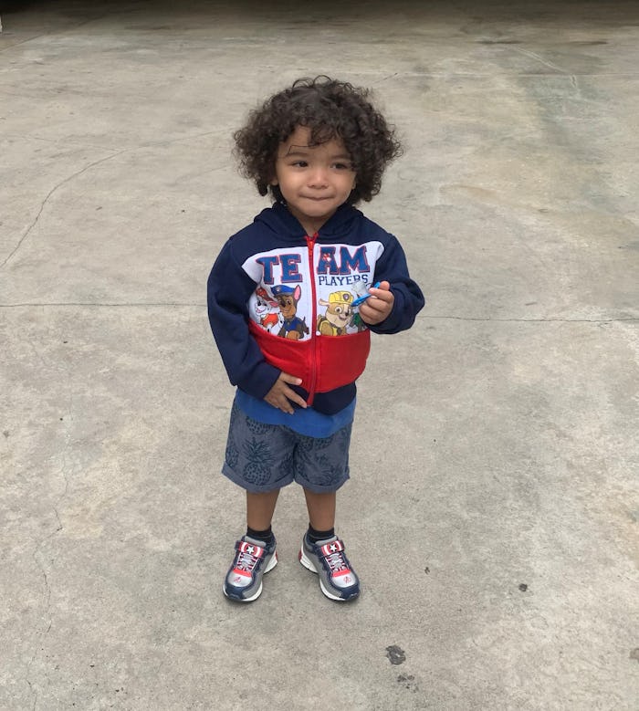 Angie Grace's 2-year-old in navy hoodie with print, navy short and blue-white sneakers