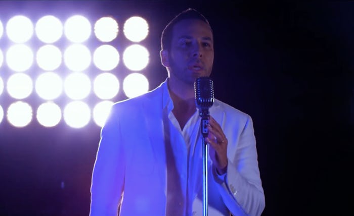 Howie from BSB singing in a white shirt