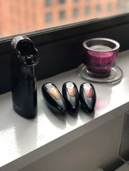 The Temptu Air works with small airpods filled with foundation, blush, and bronzer to distribute fou...