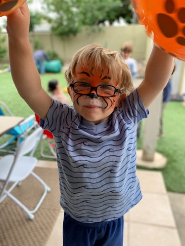 Kelly Hoover Greenway's child during birthday week wearing face paint to look like a tiger