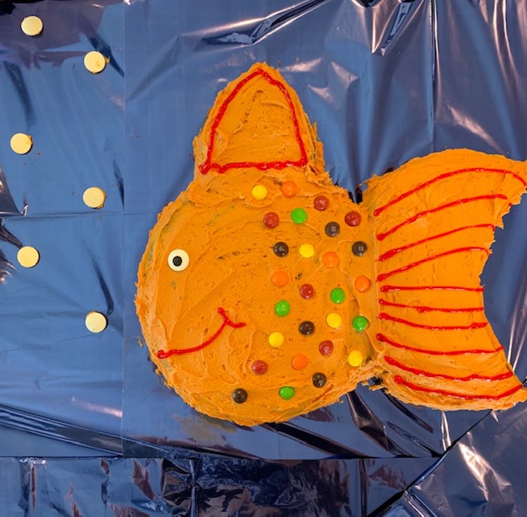 A birthday cake shaped as an orange fish