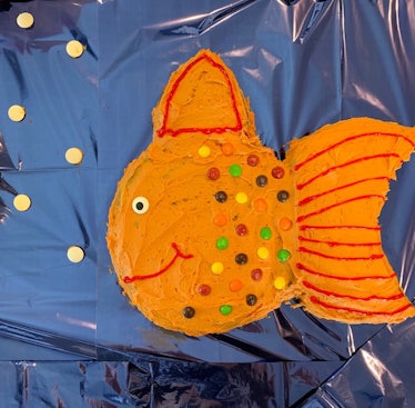 A birthday cake shaped as an orange fish