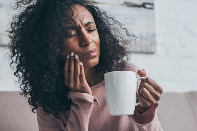 A woman holding her hadn to her face as she experiences Jaw Pain as a result of her anxiety