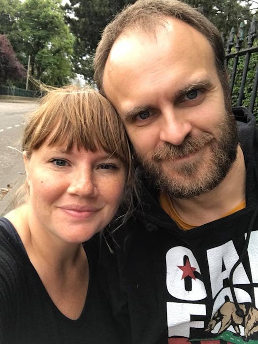 Married parent couple taking a selfie at a street