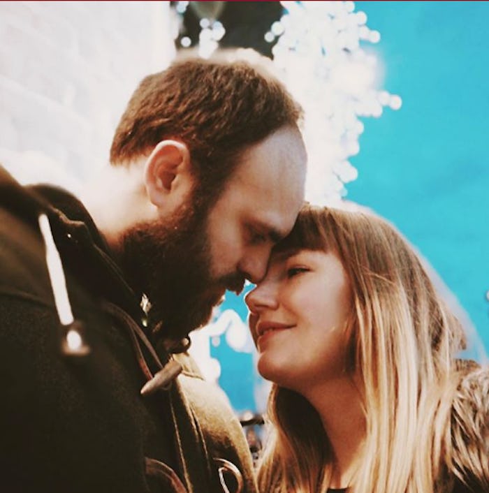 Married parent couple posing with their heads leaned