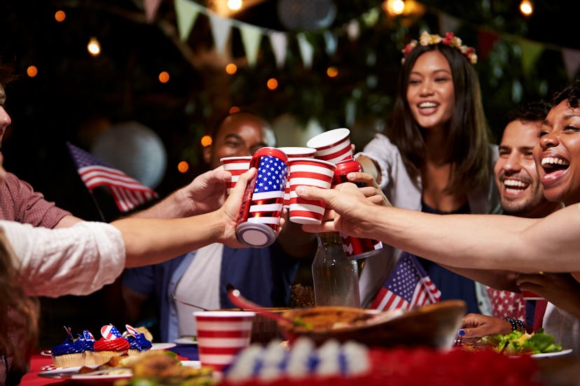 Family members toasting over a dinner table during the Fourth of July celebration