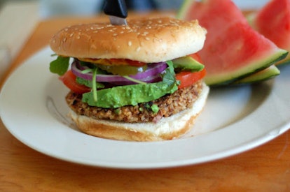 Veggie bean & rice burger served on a plate with watermelon