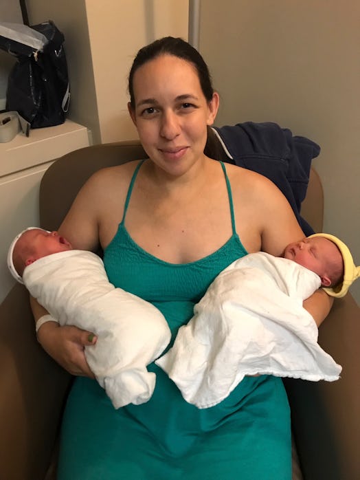 Surrogate mom Meg Stone posing for a photo with twins that she gave birth to for a couple in London 
