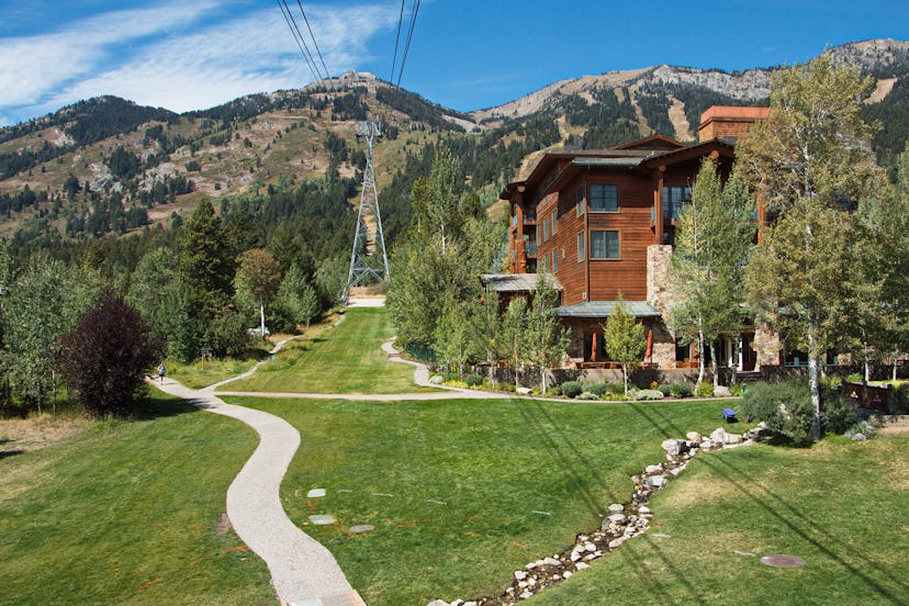 A brown wooden rustic-style house next to trees in Jackson Hole, Wyoming