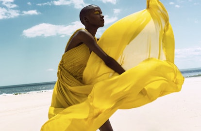 A model posing in a yellow Oscar de la Renta dress with yellow tulle sections