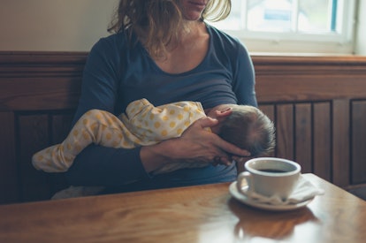 a breastfeeding mom with a cup of coffee