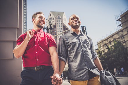 Two men holding hands and going to an LGBTQ+-owned business they found on Yelp's new feature