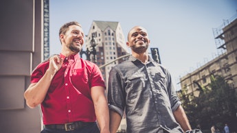 Two men holding hands and going to an LGBTQ+-owned business they found on Yelp's new feature