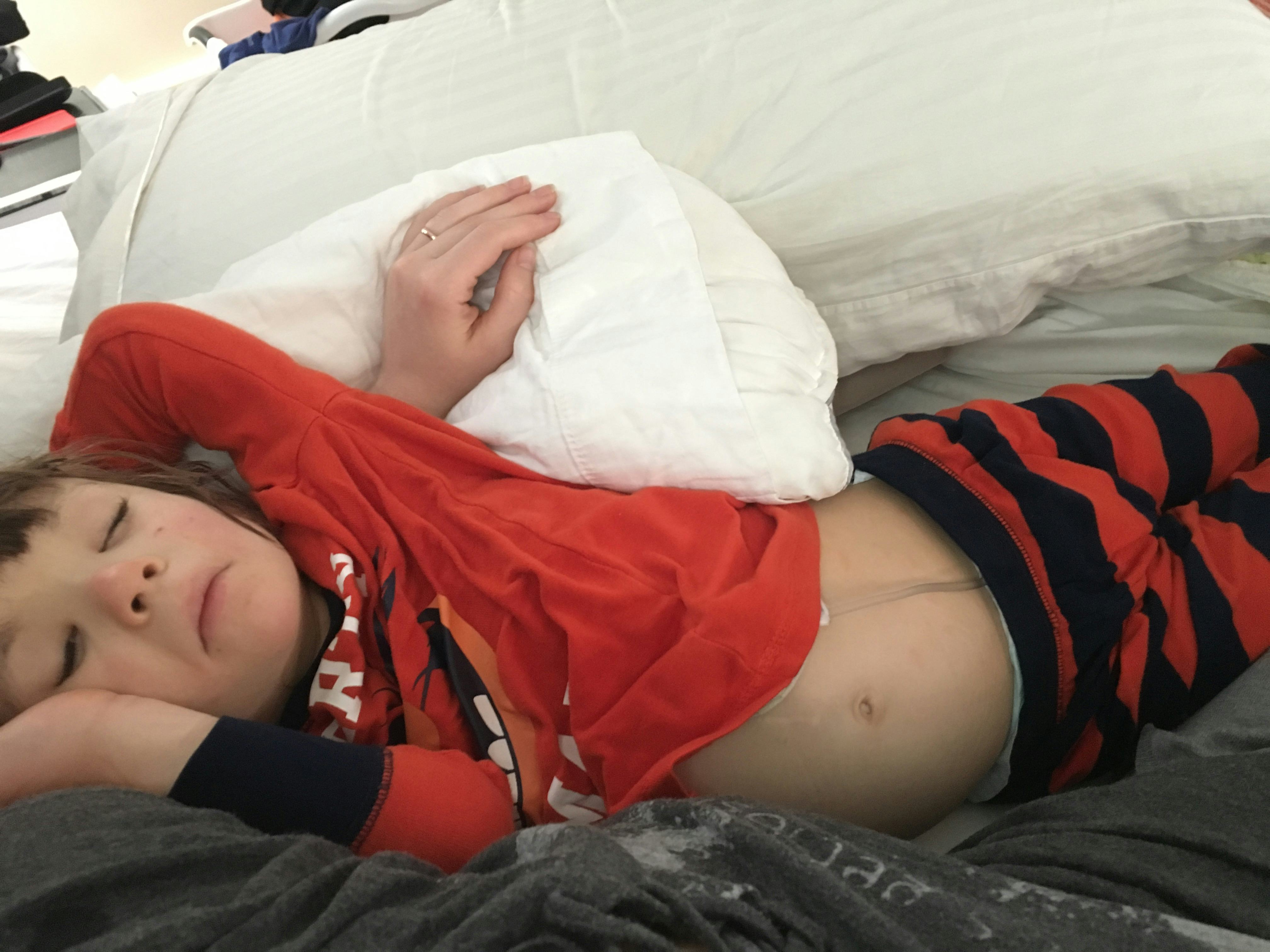 A little girl sleeping on a couch