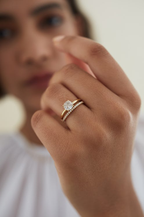 A woman posing with an engagement ring