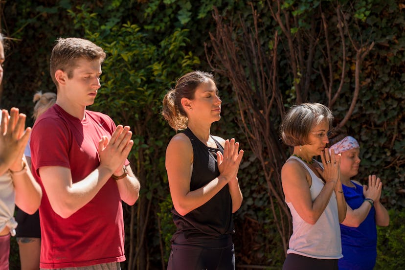 Adriene Mishler leading her yoga group in meditation