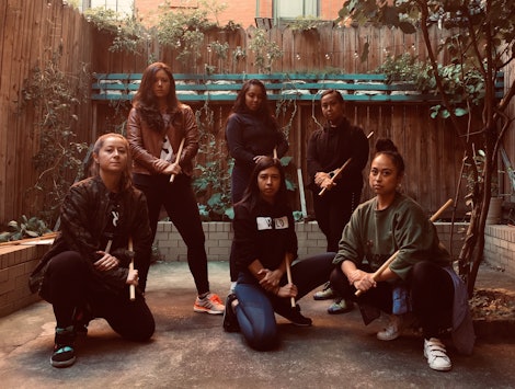 Six women that are redefining Filipino martial arts posing for a photo