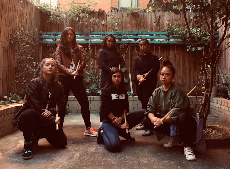 Six women that are redefining Filipino martial arts posing for a photo