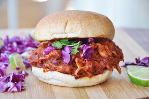 A vegan BBQ burger served on a wooden surface