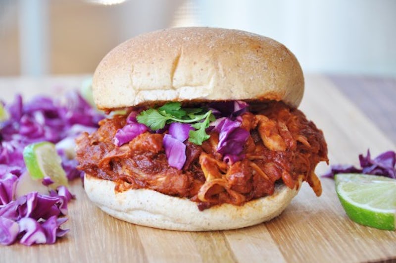 A vegan BBQ burger served on a wooden surface