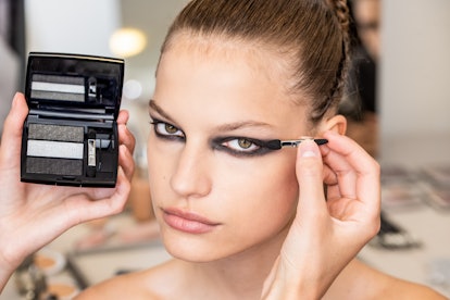 A model looking at the camera while having the Dior Haute Couture Fall/Winter 2019's Makeup Look app...
