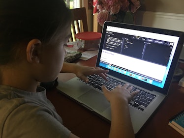 A kid on a computer programing a webpage