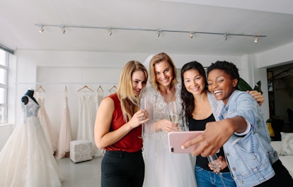 Bridal party taking a selfie before texting it to their group chat.