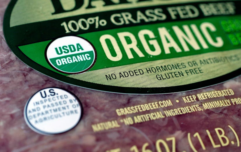 A 100% grass fed beef label with smaller USDA organic and proof of inspection labels