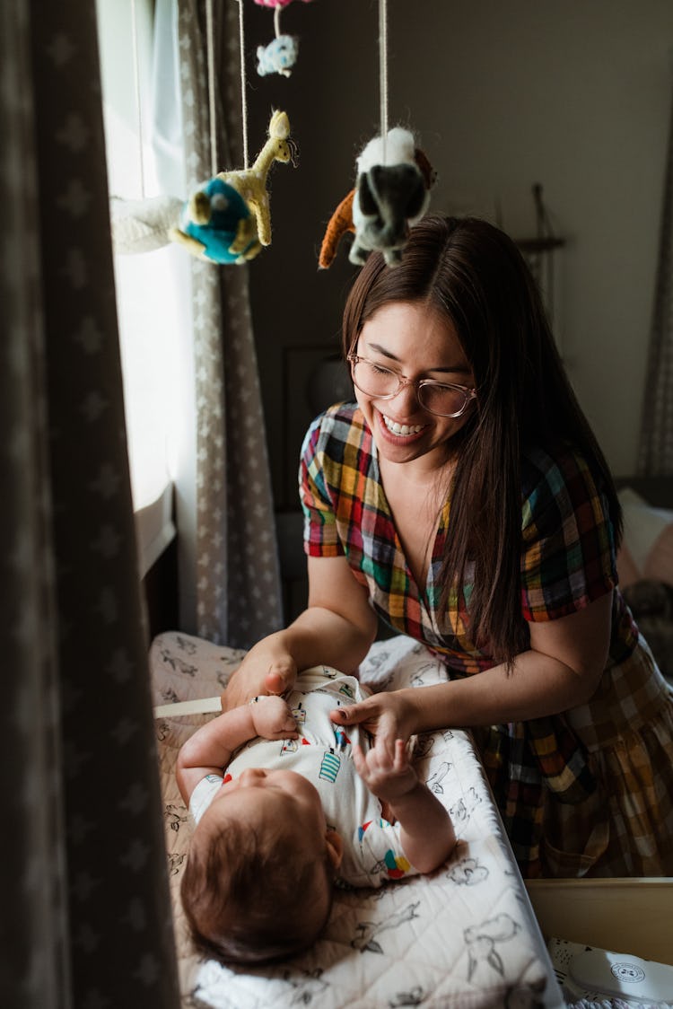 Molly Yeh's baby nursery with a Noah's Arc mobile hanging above the changing table