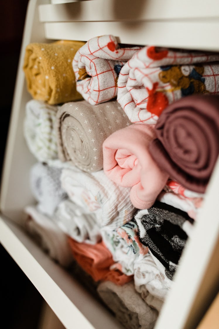 Molly Yeh's baby nursery with rolled up blankets of varying colors