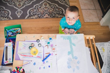 A 6-year-old Logan painting a flower