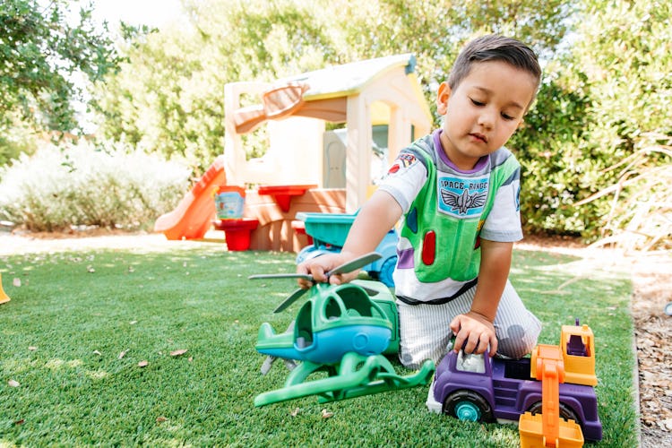 A 3-year-old Ferris playing with his toys in the garden