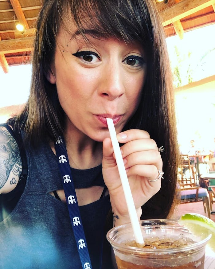 A mom on her solo vacation at the Caribbean, sipping on a drink