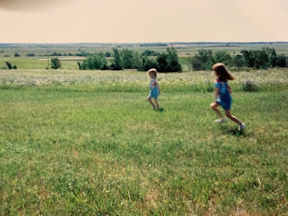 sisters running in a field