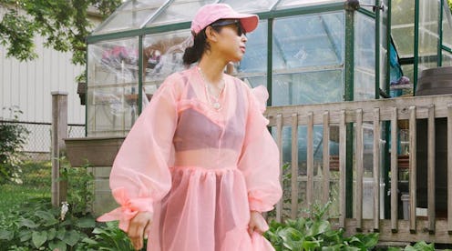 Sisilia Piring wearing a soft pink sheer dress with puffed sleeves and with matching cap