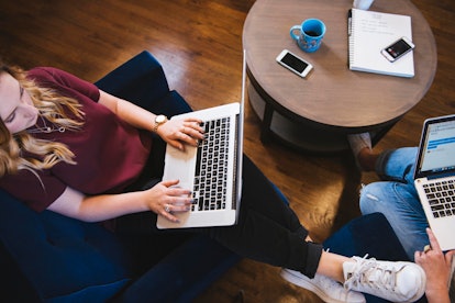 Two girls doing a lot of work on their laptops in a hub