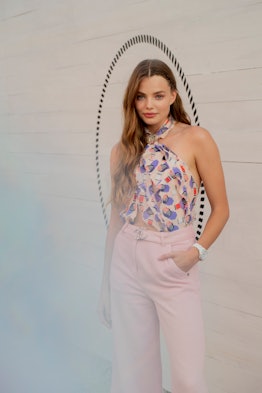 Kristine Froseth in a printed silk top and pink pants at Chanel's J12 Soiree