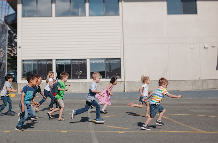 Kids running in front of a school