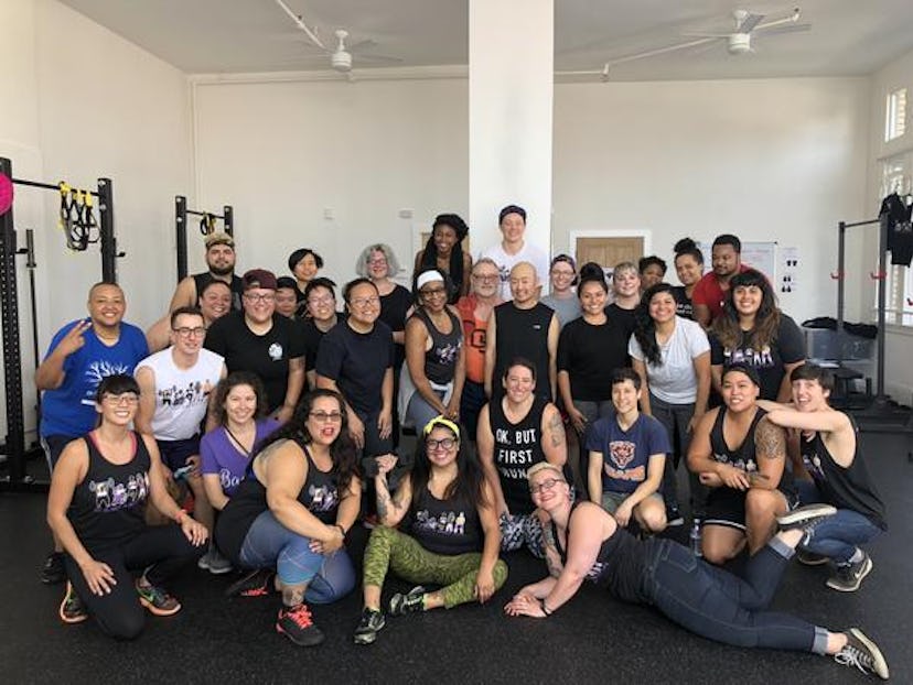 Members of Radically Fit, Oakland, pose for a group photo in the gym.