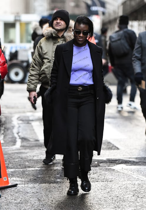 A woman wearing luxury fashion brands items walking the street