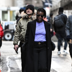 A woman wearing luxury fashion brands items walking the street