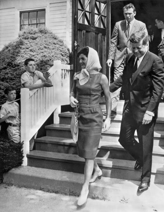 Jacqueline Kennedy Onassis and John F. Kennedy walking in court modified shoes