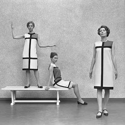 Three female models posing in black mid-'60s Roger Vivier pumps and white dresses