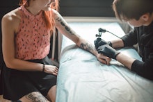 A female tattoo addict getting tattooed