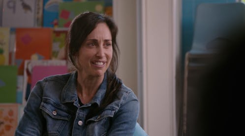 Catherine Reitman as Kate sitting in a circle with other moms and toddlers in Workin' Moms Season 2