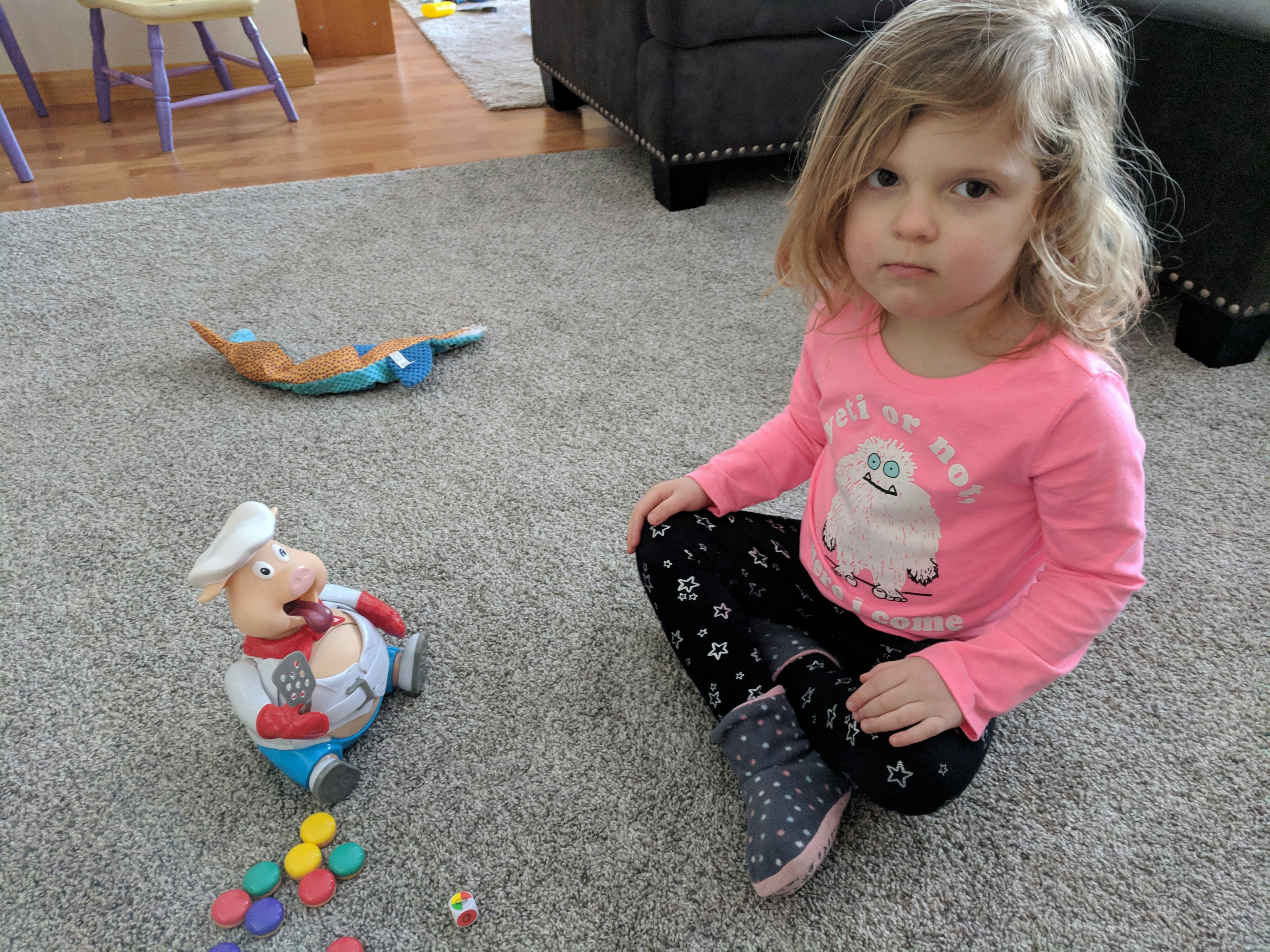 Lisa Kerslake's toddler daughter sitting on the floor and playing with her toys