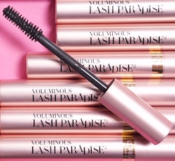 Six packages of L'Oreal Paris Lash Paradise mascara on a pink background