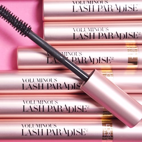 Six packages of L'Oreal Paris Lash Paradise mascara on a pink background