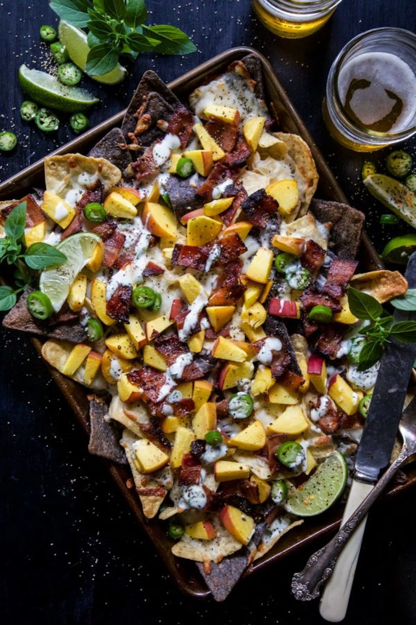 image of gluten-free sheet pan recipe- bacon peach nachos topped with jalapeno