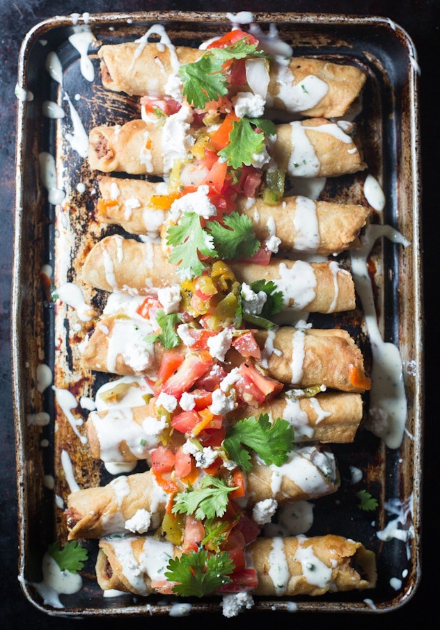gluten-free sheet pan recipe with ranch chicken flautas on pan topped with salsa and cilantro
